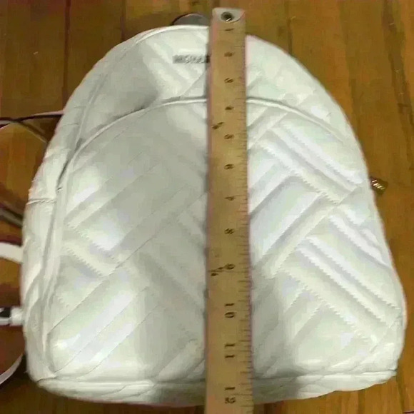 Michael‎ Kors Abbey white quilted backpack. Silver hardware. Two zipper pockets.